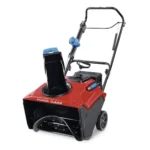 Toro Power Clear 721 QZE single stage gas snow blower clearing driveway