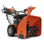 husqvarna st 224 snow blower clearing snow on residential driveway