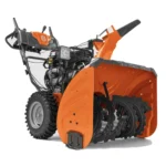 husqvarna st 330 snow blower clearing wet snow on residential driveway